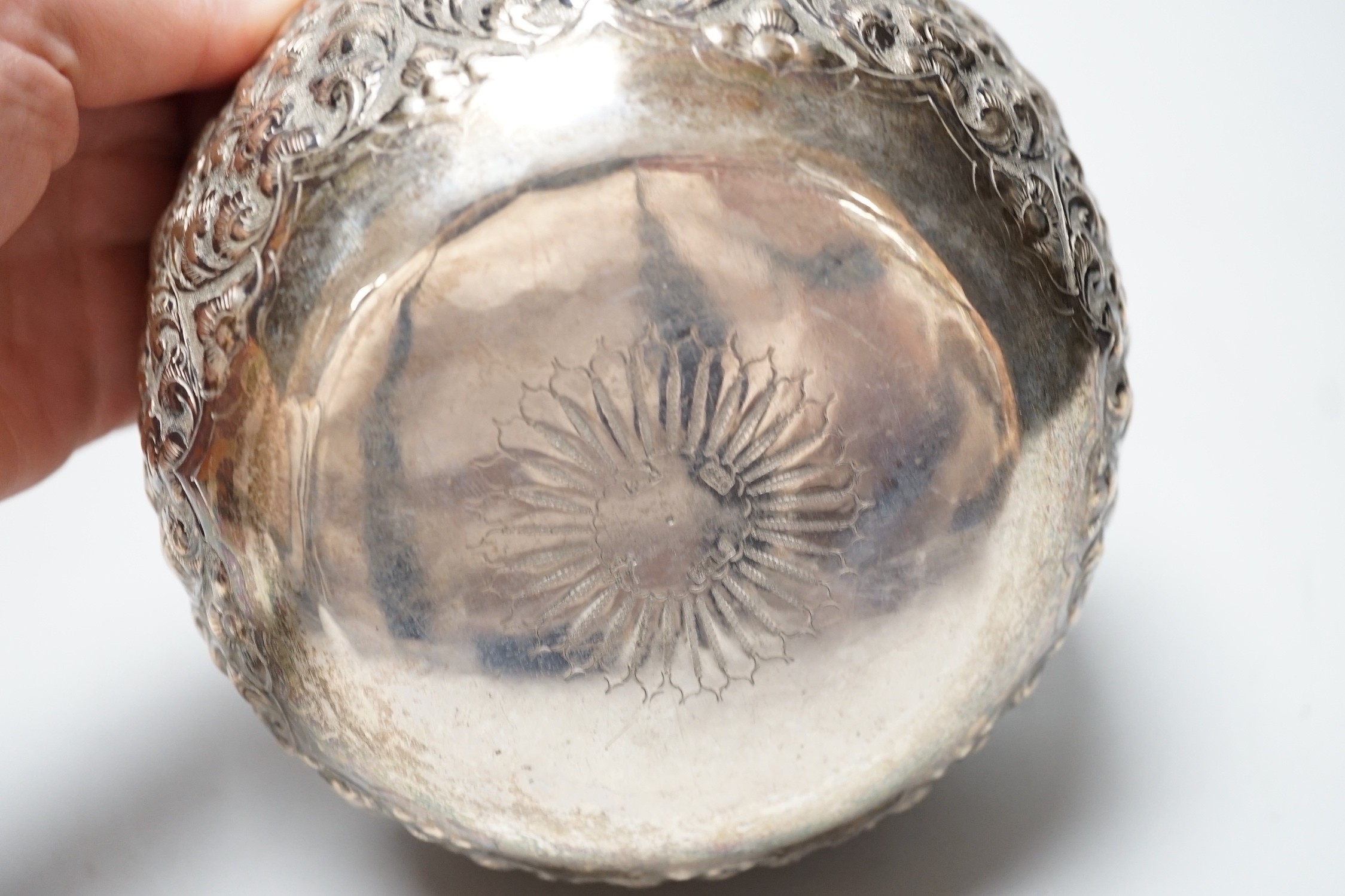 A Chinese Straits? embossed white metal bowl, indistinct marks to the base, diameter 13.9cm, 4.8oz.